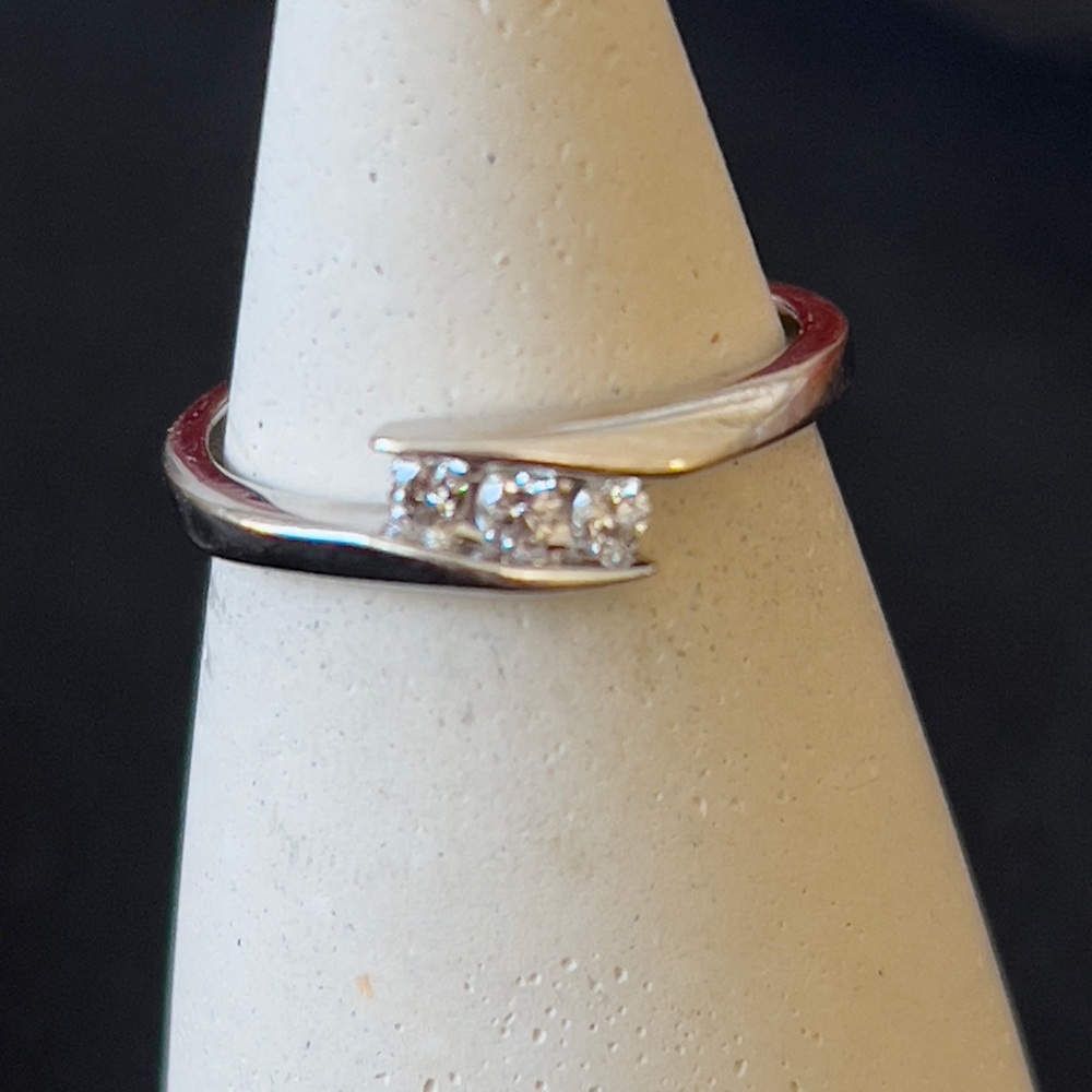 14kt white gold size 5. Three diamond ring.